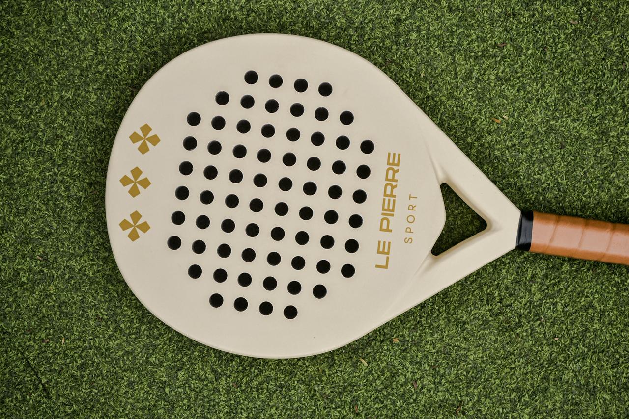Le Pierre Sport bag and racket detail with warm court styling